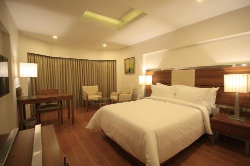 a hotel room with two beds and a television at The Residency, Chennai in Chennai