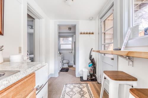 a tiny kitchen with a sink and a toilet at Cascade Cabana & Home in Hood River