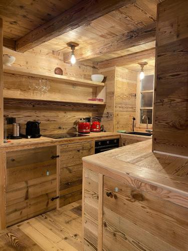a kitchen with wooden walls and wooden counters at Rascard Monterosa in Champoluc