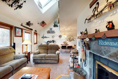 a living room with couches and a fireplace at Stratton Hideway in Stratton