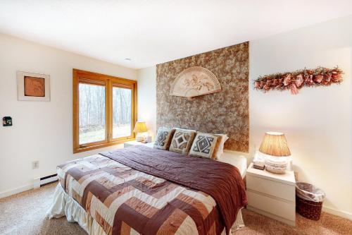 a bedroom with a large bed and a window at Stratton Hideway in Stratton