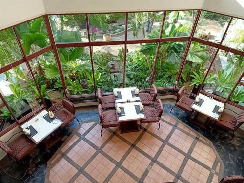 an overhead view of a restaurant with tables and chairs at Felix River Kwai Resort - SHA Plus,Certified in Kanchanaburi