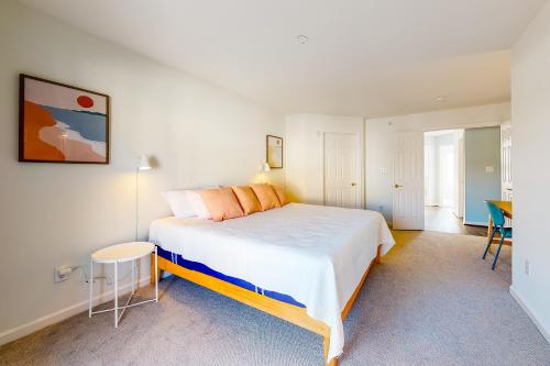a bedroom with a large bed and a table at Bayside at Bethany Lakes #143 in Ocean View