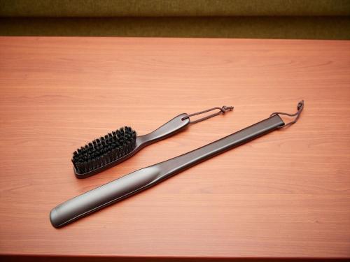 a toothbrush sitting on top of a wooden table at THE GRAND HOTEL GINOWAN in Ginowan
