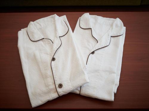 a white shirt sitting on top of a wooden table at THE GRAND HOTEL GINOWAN in Ginowan