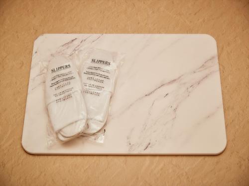 a white counter top with a towel and a sock at THE GRAND HOTEL GINOWAN in Ginowan