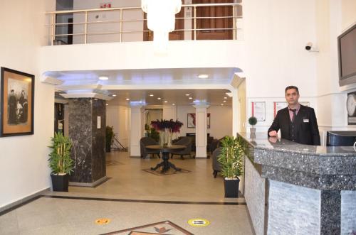 a man standing at a counter in a lobby at Antik Ipek Hotel in Istanbul