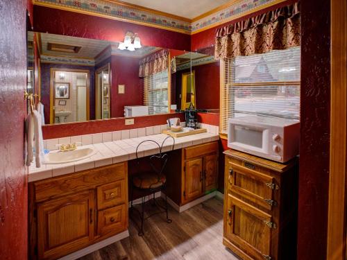 a bathroom with a sink and a bathtub at Cathy's Cottages in Big Bear Lake