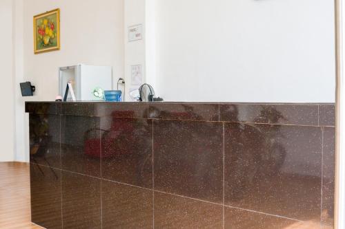 a kitchen with a counter top and a sink at Hotel O Papakoel in Medan