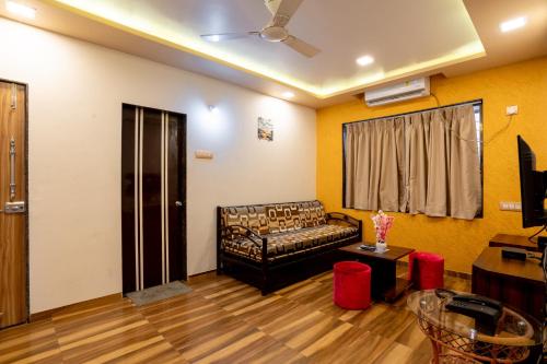 a living room with a couch and a table at Pooja Villa Suites-Rooms and Pool, Igatpuri in Igatpuri