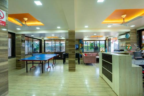 a restaurant with two ping pong tables in a room at Pooja Villa Suites-Rooms and Pool, Igatpuri in Igatpuri
