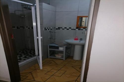 a bathroom with a shower and a sink at Maluti Backpackers in Phuthaditjhaba