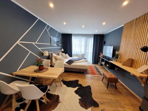 a living room with a couch and a table at Cool Studio - Apartment in Gosau - Hallstatt - Wellness and Pool included in Gosau
