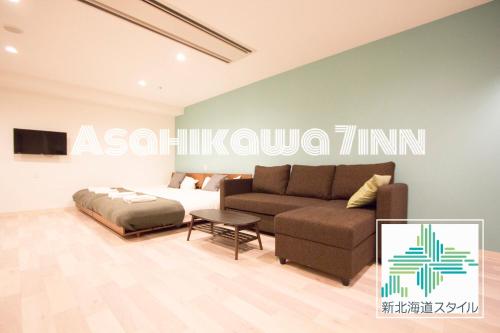 a living room with a couch and a bed at Hokkaido Asahikawa 7 - inn in Asahikawa