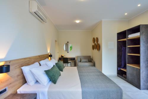a bedroom with a large bed and a couch at Ilingas Mare in Khóra Sfakíon