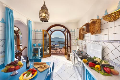 a kitchen with a counter with fruits and vegetables on it at Villa Lia in Massa Lubrense