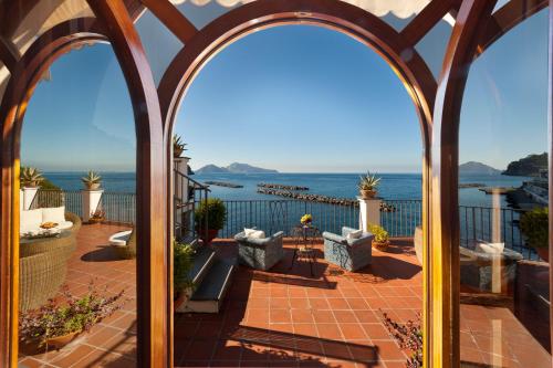 a view of the ocean from the balcony of a house at Villa Lia in Massa Lubrense
