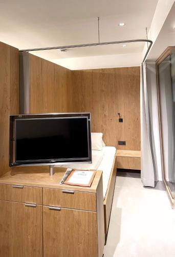 a living room with a large flat screen tv at Apartmenthaus Anna mit Self-Check-In und 24h Support in Lustenau