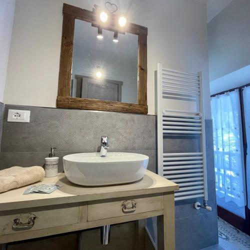 a bathroom with a sink and a mirror at Rifugio Baita Gimont in Cesana Torinese