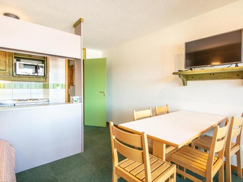a kitchen and dining room with a table and chairs at Vacancéole - Résidence Le Sappey - Doucy in La Léchère