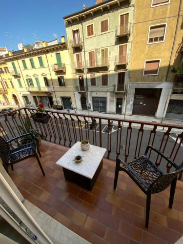 a balcony with a table and chairs and buildings at Chez Telly 31 in Verona
