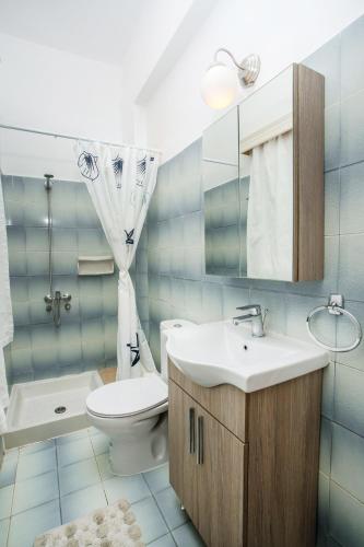 a bathroom with a sink and a toilet and a mirror at Sabrina Studios in Faliraki