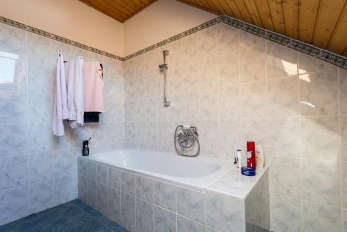a bathroom with a bath tub in a room at Farmhouse in Köveskál (Balatonfelvidék) for 6 persons in Köveskál
