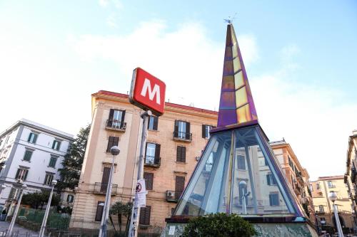 a sign and a clock in front of a building at Materdays 24 in Naples