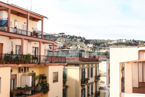 a group of buildings with a hill in the background at Materdays 24 in Naples