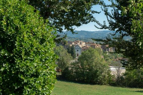 a view of a city through the trees at Villa al Confine by Mmega in Calzolaro