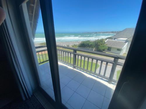 a view of the ocean from a room with a window at Shalom-self catering apartment in St Francis Bay