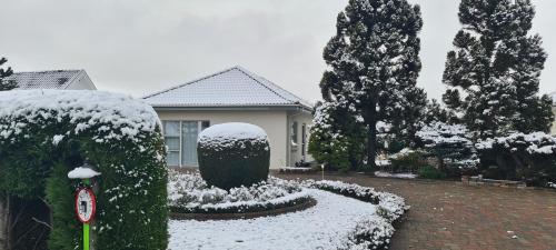 a house with a yard covered in snow at Cichy zakątek in Odense
