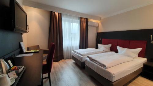 Postel nebo postele na pokoji v ubytování Astralis Hotel Domizil