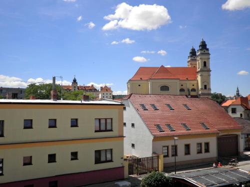 a group of buildings with a church in the background at Vila Edith Valtice in Valtice