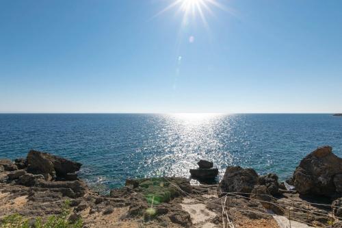 a view of the ocean from a rocky beach at Armonia Seaside Villas in Vasilikos