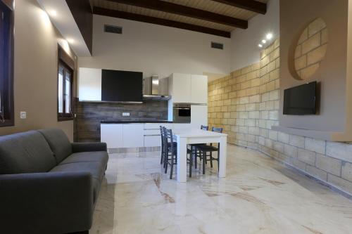 a living room with a couch and a table at La Piana Hotel in Tito