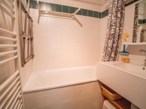 a white bathroom with a tub and a sink at Appartement Valmorel, 1 pièce, 4 personnes - FR-1-356-194 in Valmorel
