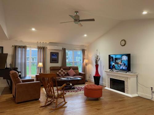 a living room with a couch and a fireplace at By The Bay Stratford The Romeo Home in Stratford