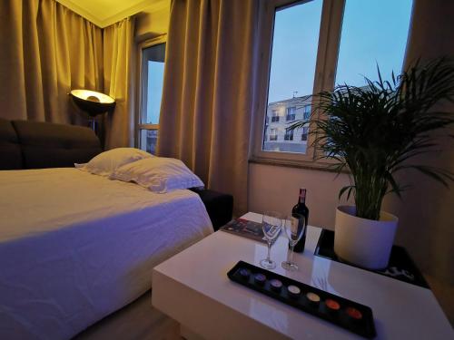 a hotel room with a bed and a table with a plant at Sweet Lime Apartments Kaszubska 57m2 in Wrocław