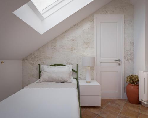 a white bedroom with a bed and a white door at Vila Perast Boutique Hotel in Perast