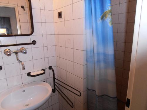 a bathroom with a sink and a shower at Penzion u České Koruny in Jičín