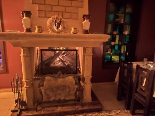 a fireplace in a living room with a fire place at Equi Palace & SPA Near Aeroport in Berrechid