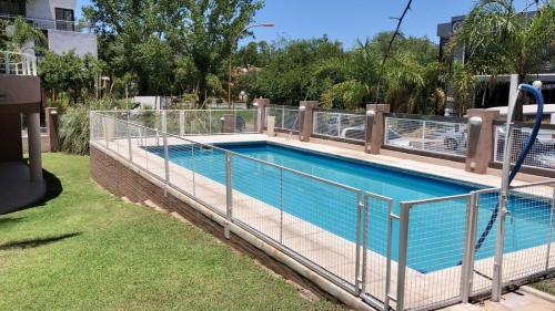 a swimming pool with a metal fence around it at Depto 8 - Villa Carlos Paz in Villa Carlos Paz