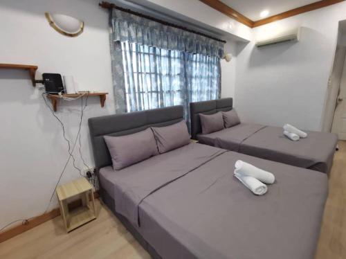 a living room with a bed and a couch at Seremban Grande Villa 163 by Vale Pine in Seremban