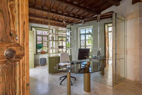 an office with a glass table and chairs at Neratze Hammam Suites in Rethymno Town