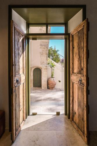 an open door with a view of a courtyard at Neratze Hammam Suites in Rethymno Town