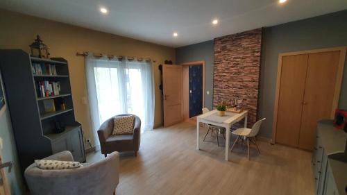 a living room with a table and a chair at Bed'N'Bulles - Wellness privatif in Dinant
