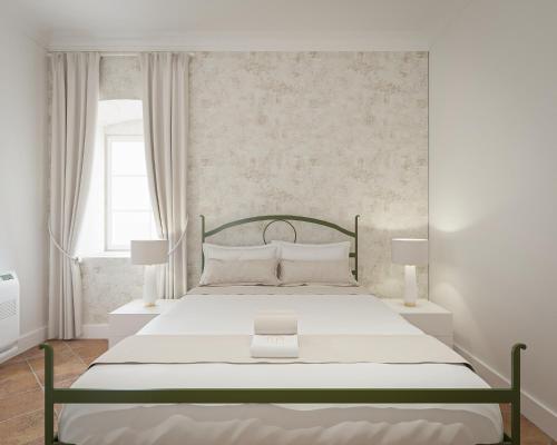 a bedroom with a large bed with a green frame at Vila Perast Boutique Hotel in Perast