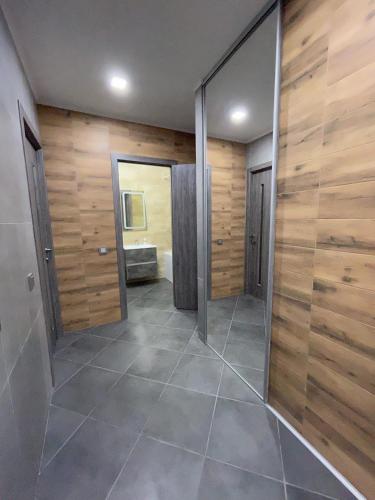 a bathroom with a walk in shower and a mirror at Evro Lux 3 комнаты in Kherson
