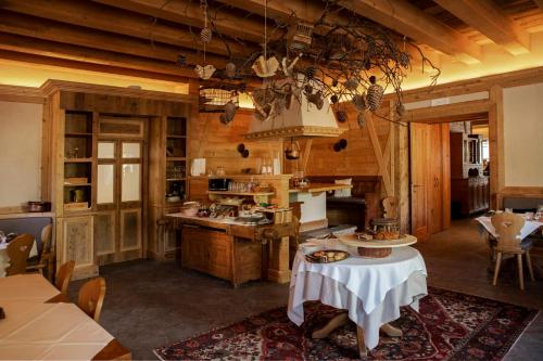 a large kitchen with wooden walls and wooden floors at Al Capriolo in Vodo Cadore